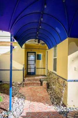 a large purple umbrella in front of a building at Coronado Inn in San Diego