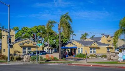 a row of houses on a street with a palm tree at Coronado Inn in San Diego