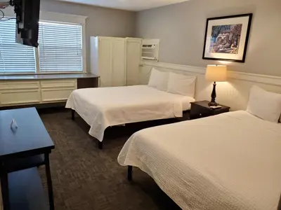 a hotel room with two beds and a window at Coronado Island Inn in San Diego