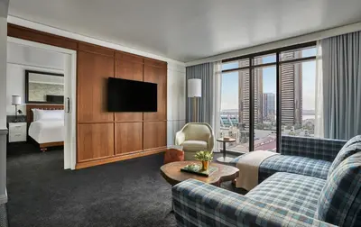a hotel room with a couch and a tv at Pendry San Diego in San Diego