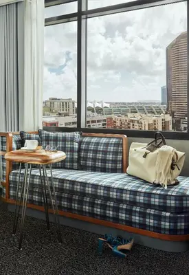 a couch sitting in front of a large window at Pendry San Diego in San Diego