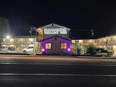 a building with purple lights on the side of it at Ramona Valley Inn - Ramona in Ramona