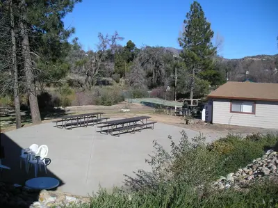a group of picnic tables in a park at Oakzanita Springs Camping Resort Cabin 2 in Descanso