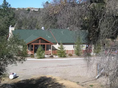 a house with a green roof and a yard at Oakzanita Springs Camping Resort Cabin 2 in Descanso