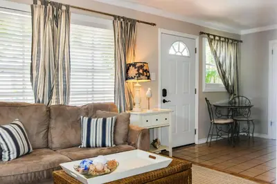 a living room with a couch and a table at La Jolla Cottage in San Diego