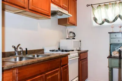 a kitchen with a sink and a stove at La Jolla Cottage in San Diego