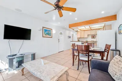 a living room with a couch and a tv and a table at Mike's Place at the Beach in San Diego