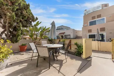 a patio with a table and chairs and an umbrella at Sweet Sunset Studio in San Diego