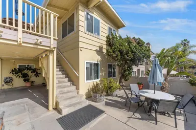 a house with a patio with a table and chairs at Sweet Sunset Studio in San Diego