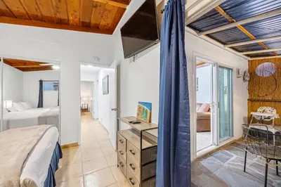 a bedroom with a bed and a desk in a room at Mimi's & Nana's Beach House in San Diego