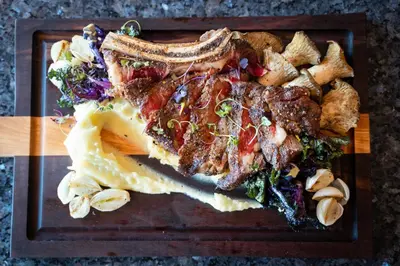 a plate of food with meat and vegetables on a table at The Dana on Mission Bay in San Diego
