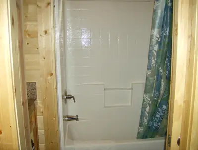 a shower in a bathroom with a white tub at Pio Pico Camping Resort Cottage 4 in Jamul