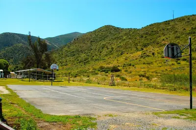 an empty parking lot with mountains in the background at Pio Pico Camping Resort Cottage 4 in Jamul