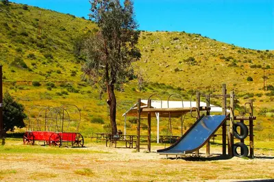 a playground with a slide and a slideintend at Pio Pico Camping Resort Studio Cabin 7 in Jamul