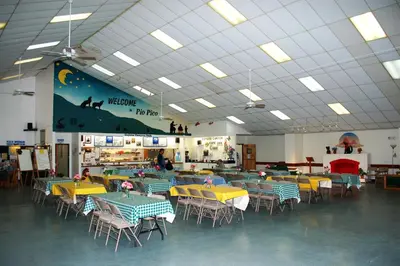 a cafeteria with tables and chairs in a room at Pio Pico Camping Resort Studio Cabin 10 in Jamul