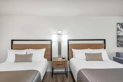 a hotel room with two beds and a table at Wyndham Garden San Diego in San Diego
