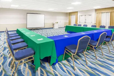 a conference room with blue and green tables and chairs at Wyndham Garden San Diego in San Diego