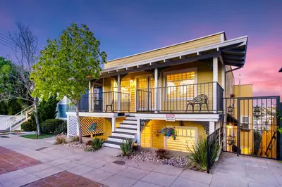 a house with a balcony and stairs in front of it at Casa San Diego - Spacious Getaway with Backyard, Firepit, Kid Zone in San Diego