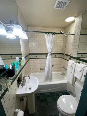 a bathroom with a sink and a tub and a toilet at Cherokee Lodge in San Diego