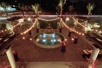 a courtyard with lights and a fountain at night at Hilton Garden Inn San Diego Old Town/Sea World Area in San Diego