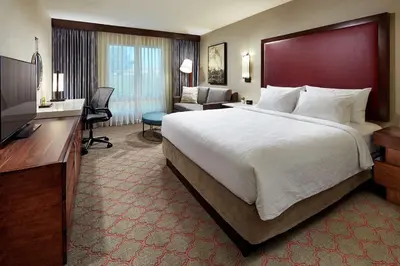 a hotel room with a large bed and a television at Hilton Garden Inn San Diego Old Town/Sea World Area in San Diego
