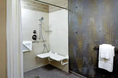 a bathroom with a shower with a toilet and a sink at Hilton Garden Inn San Diego Old Town/Sea World Area in San Diego