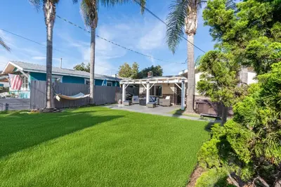 a house with a yard with a hammock at Oceanside Rocks Family Vacation Home in Oceanside