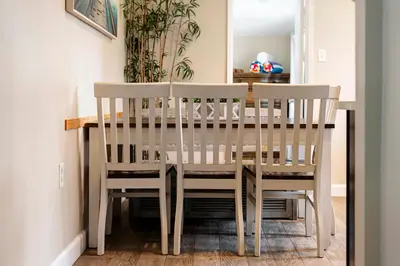 a dining room table with two chairs around it at Oceanside Rocks Family Vacation Home in Oceanside