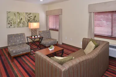 a living room with a couch and two chairs at Pleasant Inn in San Diego
