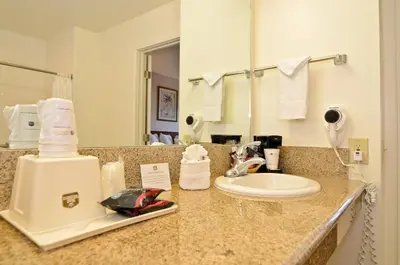 a bathroom counter with a sink and a mirror at Pleasant Inn in San Diego