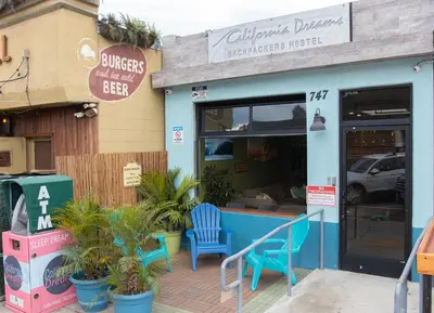 a store with two blue chairs outside of it at California Dreams Hostel - Pacific Beach in San Diego