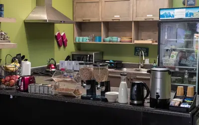 a kitchen with a counter with some food on it at California Dreams Hostel - Pacific Beach in San Diego