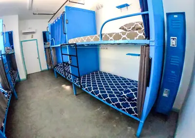 a small room with two bunk beds on a train at California Dreams Hostel - Pacific Beach in San Diego