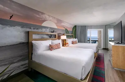 a hotel room with two beds and a tv at The Wayfarer San Diego in San Diego