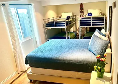 a bedroom with two bunk beds and a window at Sweet Beach Duplex in Newport Beach