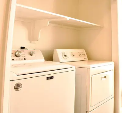 a small laundry room with a washer and dryer at Sweet Beach Duplex in Newport Beach