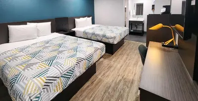 a hotel room with two beds in a room at Studio 6 Suites San Ysidro CA San Diego South Bay in San Ysidro, San Diego