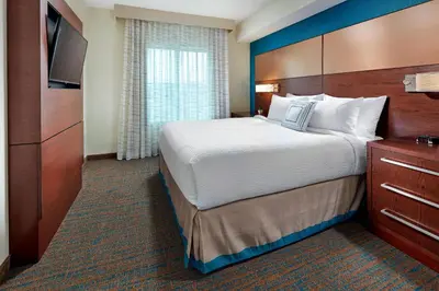a hotel room with a large bed and a television at Residence Inn by Marriott San Diego Chula Vista in Chula Vista