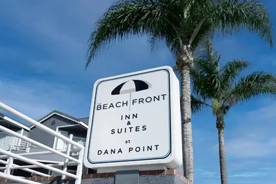a sign that reads beach front inn and suites at dana point at Beachfront Inn and Suites at Dana Point in Capistrano Beach