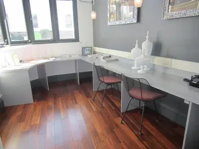 a room with two desks with chairs and windows at La Pensione Hotel in San Diego