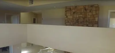 a staircase in a room with a stone wall at Mansion on the Hill let 4 Rooms, 5th cost extra in Sage