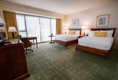 a hotel room with two beds and a desk at The Westgate Hotel in San Diego