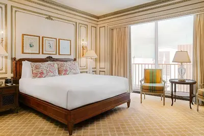 a bedroom with a large bed and a balcony at The Westgate Hotel in San Diego