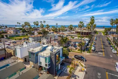 an aerial view of a city with palm trees and the ocean at Modern Beach Home Steps To The Sand in San Diego