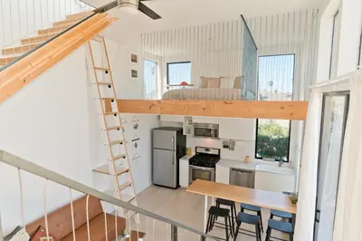 a kitchen and dining room with a loft at Modern Beach Home Steps To The Sand in San Diego