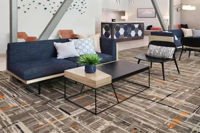 a living room with a blue couch and a table at Homewood Suites By Hilton San Diego Central in San Diego