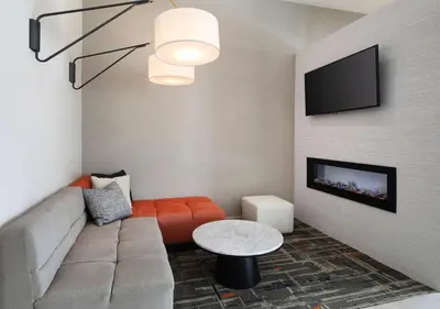 a living room with a couch and a tv at Homewood Suites By Hilton San Diego Central in San Diego
