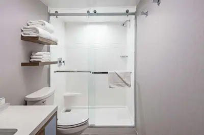 a bathroom with a toilet and a glass shower at Homewood Suites By Hilton San Diego Central in San Diego
