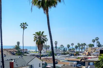 a view of a city with palm trees and the ocean at New Beach House, Steps to Sand in San Diego