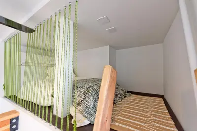 a small bedroom with a bed and a window at New Beach House, Steps to Sand in San Diego